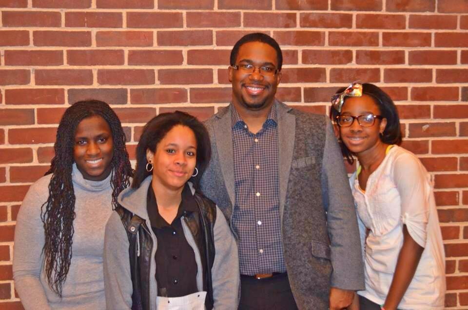 Geo taking pictures with students after an anti-bullying assembly.